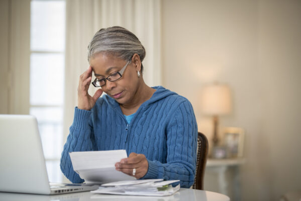 Senior African American woman paying bills